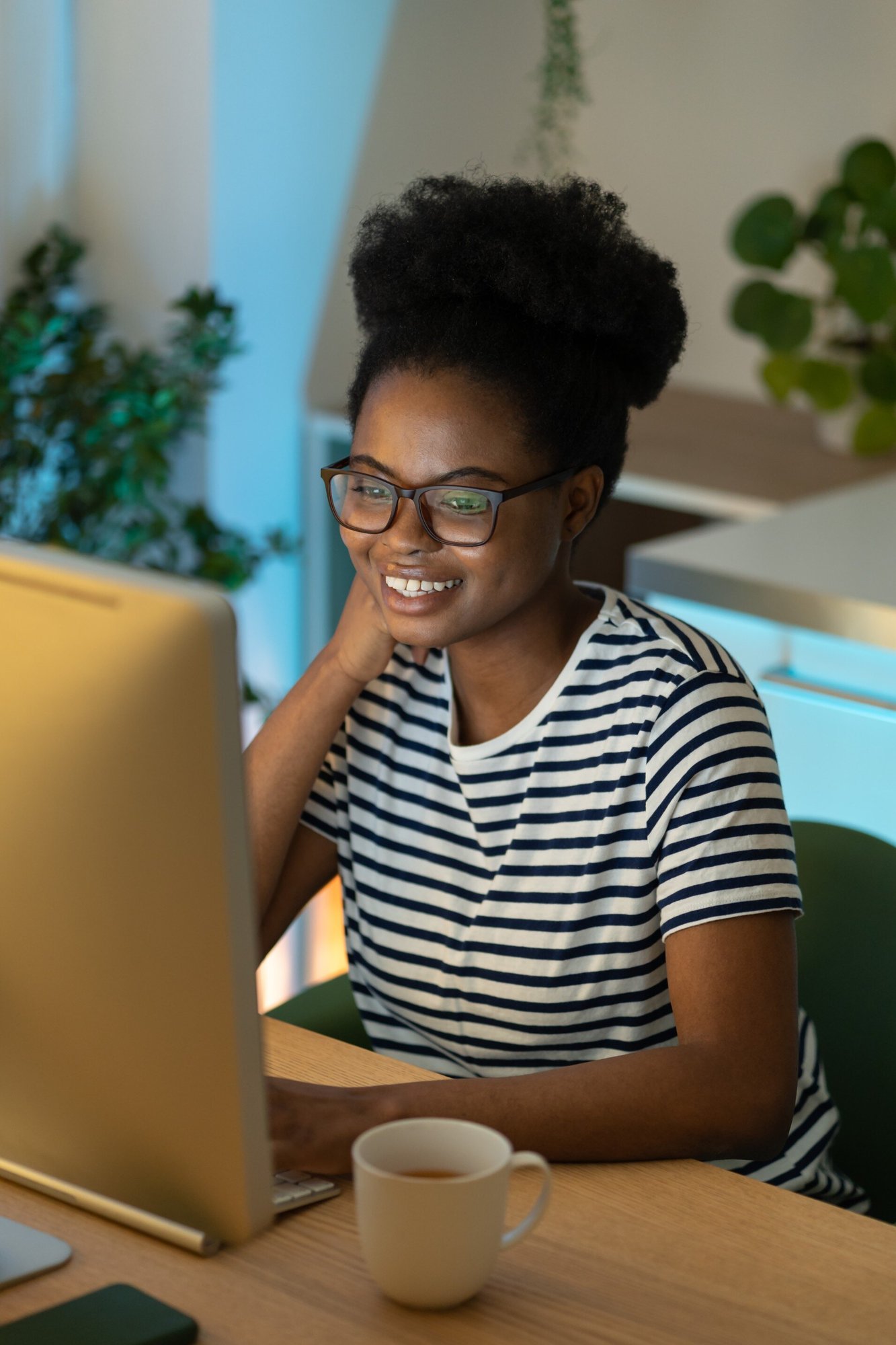 Smiling Woman Working on Computer - Stock Image